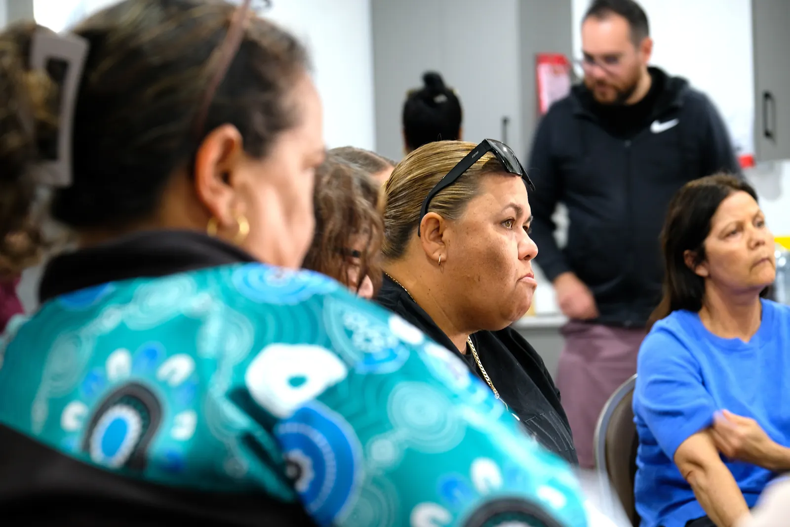 Women listening closely during a community session.